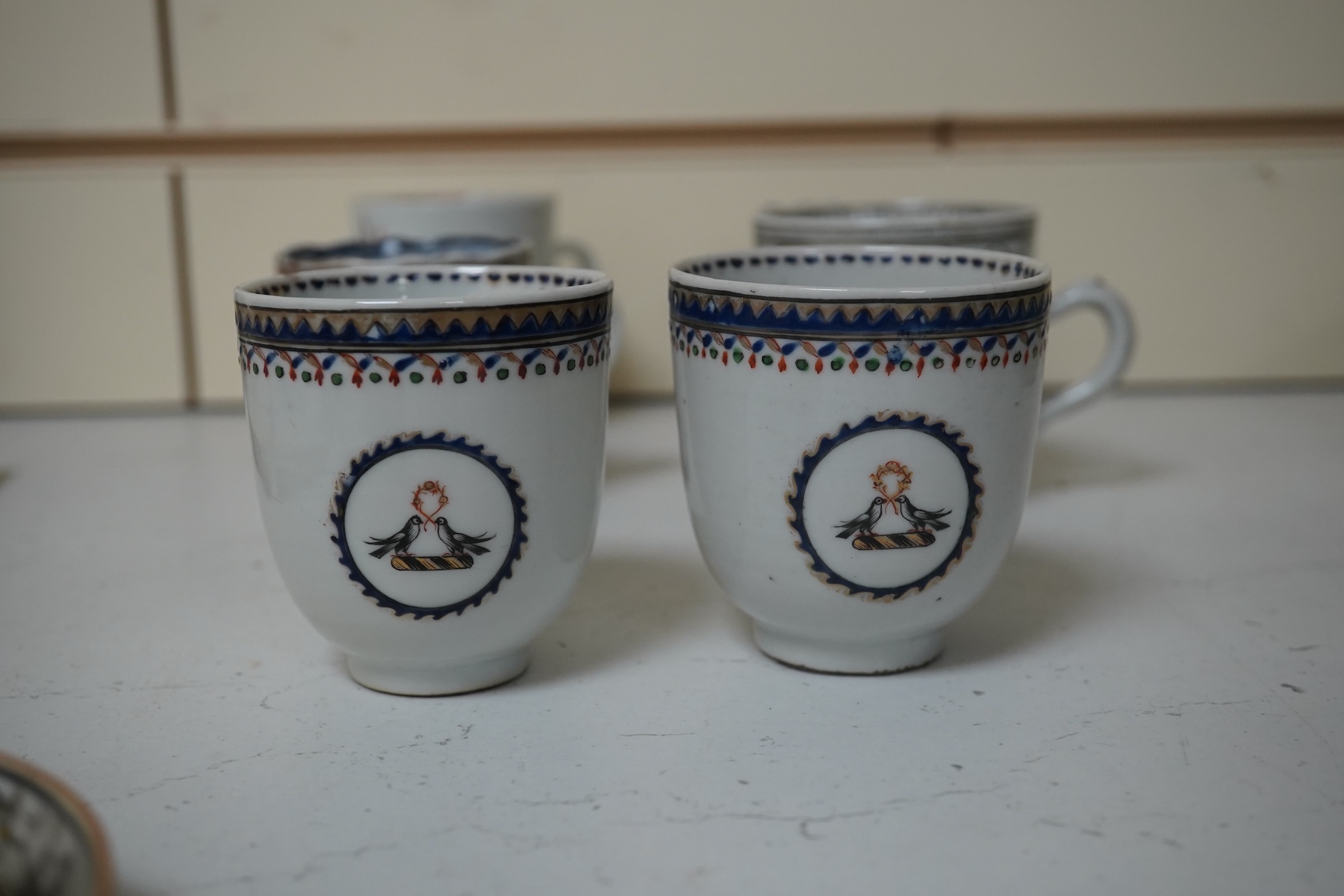 Six assorted 18th century Chinese export coffee cups with armorial decoration, and a similar European subject cup and saucer. Condition - damaged/restored